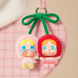 Pop Mart Labubu earrings with colorful hair and dresses, hanging from a pink drawstring bag.