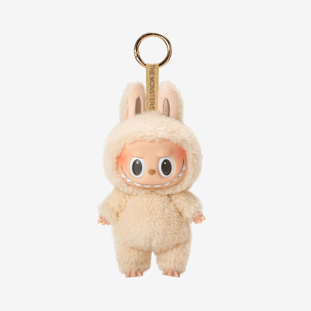 POP MART Labubu The Monsters keychain in a beige costume with a gold tag on a white background
