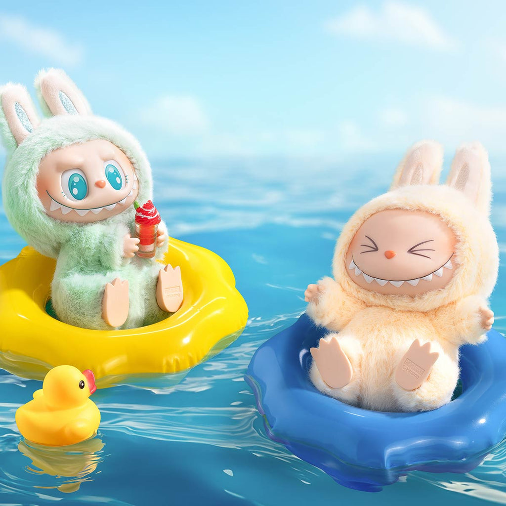 Two Pop Mart Labubu in inflatable rings on water with a rubber duck nearby.