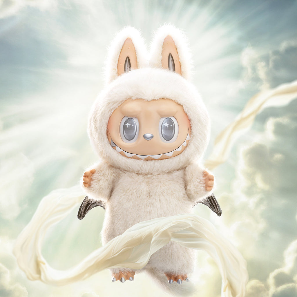 Pop Mart Labubu resembling a cute creature with large eyes and a soft texture, set against a light, blurred background.
