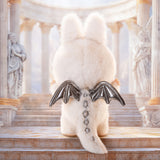 White Pop Mart Labubu with silver wings on a decorative staircase