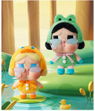 Two Pop Mart Labubu, one in a yellow outfit and the other in a green outfit with a frog hat, standing on a lily pad in a pond.