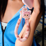 Person wearing a blue jacket with a Pop Mart Labubu keychain on an arm.