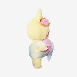 Monsters Labubu with a yellow hood and pink accents on a white background