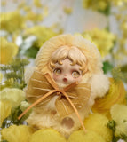 Small POP MART’s Skullpanda with blonde hair and a bow surrounded by yellow flowers