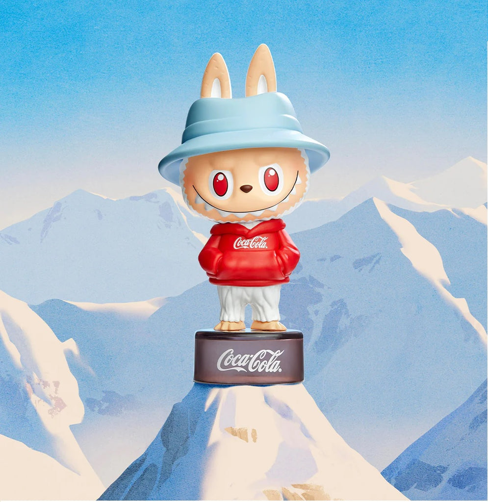 POP MART Labubu Coca cola Series wearing a Coca-Cola hoodie with a mountainous background