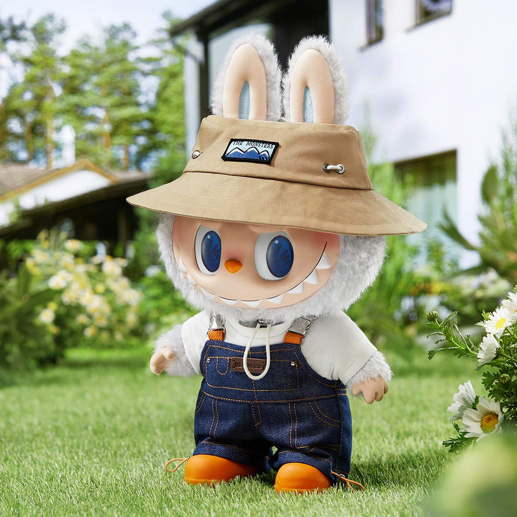 POP MART Labubu with bunny ears and a hat standing on grass