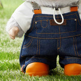 POP MART Labubu wearing blue denim overalls with orange shoes on grass