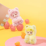 Two POPMART HACIPUPU Gummy Bear Series, one pink and one yellow, on a yellow background with pink and orange balls.