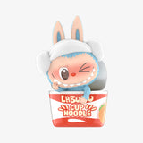 Pop Mart Labubu with bunny ears sitting on a Cup Noodle container