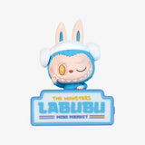 Pop Mart the Labubu Monsters with a blue hat and sign reading 'The Monsters Labubu Mini Market' on a white background