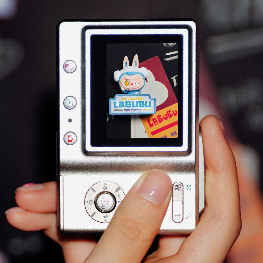 Hand holding a vintage-style music player with a Pop Mart the Labubu Monsters on the screen