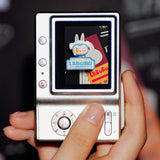Hand holding a vintage-style music player with a Pop Mart the Labubu Monsters on the screen