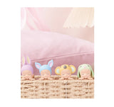 Four Sonny Angel Hipper Dreaming Series with colorful hair accessories in a basket on a pink background