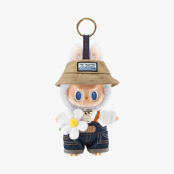 Keychain with Pop Mart the Labubu Monsters wearing a hat and overalls on a white background