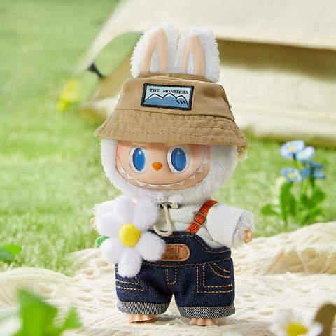 Pop Mart the Labubu Monsters with bunny ears and a hat holding a flower, standing outdoors.