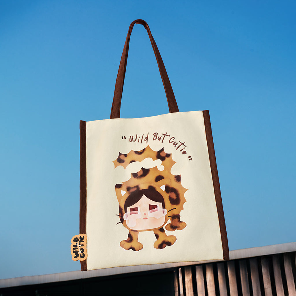 POP MART Wild but Cutie Bag with cartoon hedgehog design and 'Wild But Cutie' text against a blue sky.