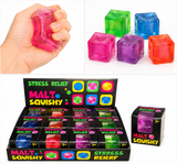 Translucent malt sugar squeeze cube being pressed for tactile sensory relief