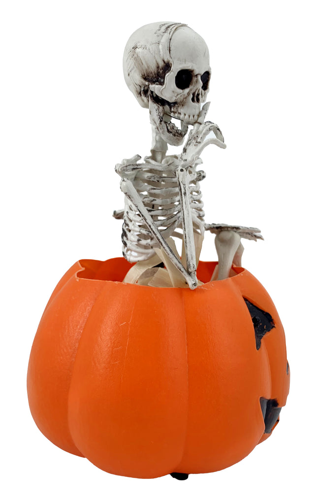 Skeleton Sitting on Pumpkin